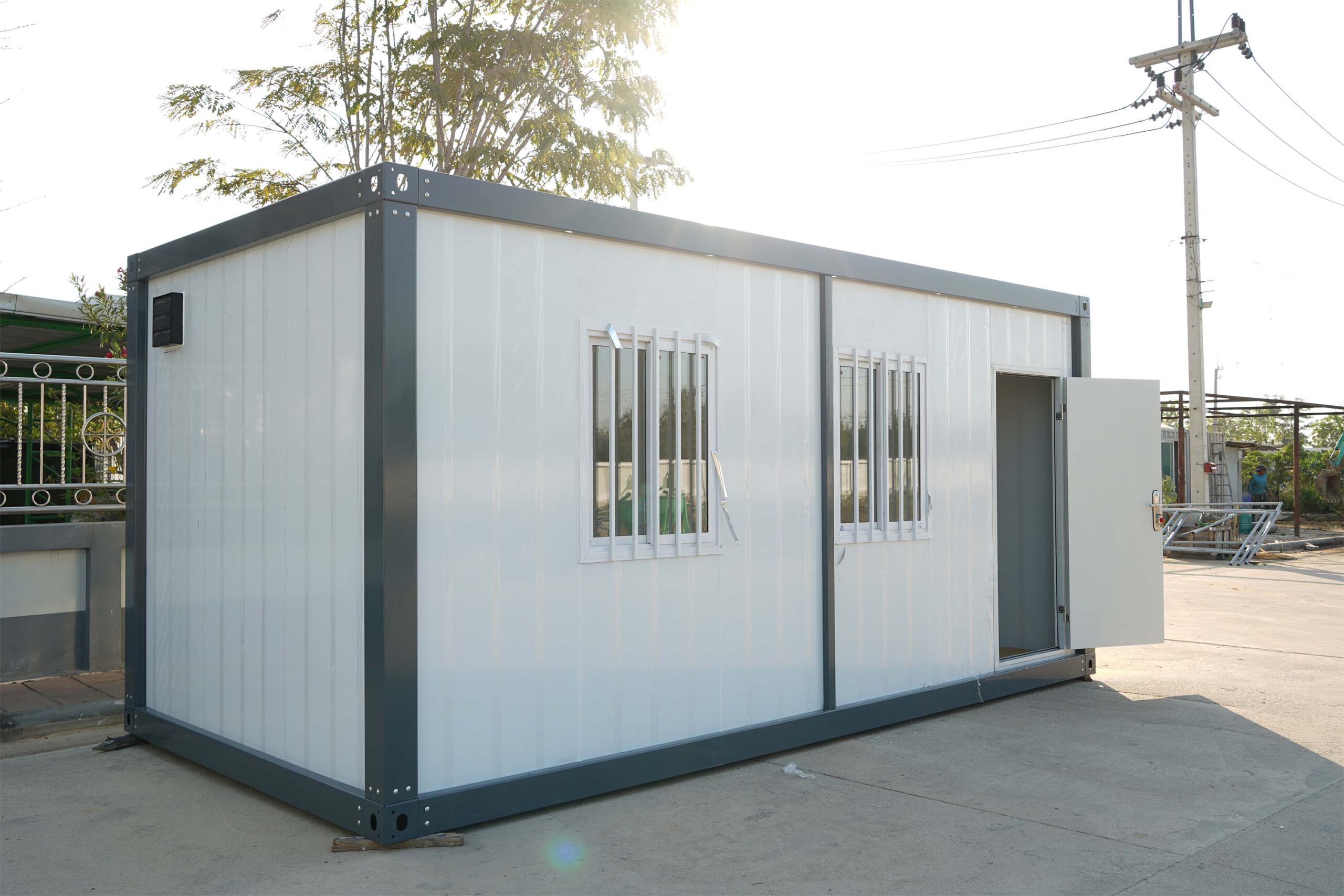 TheContainerTH prefabricated container unit — angled view with open door