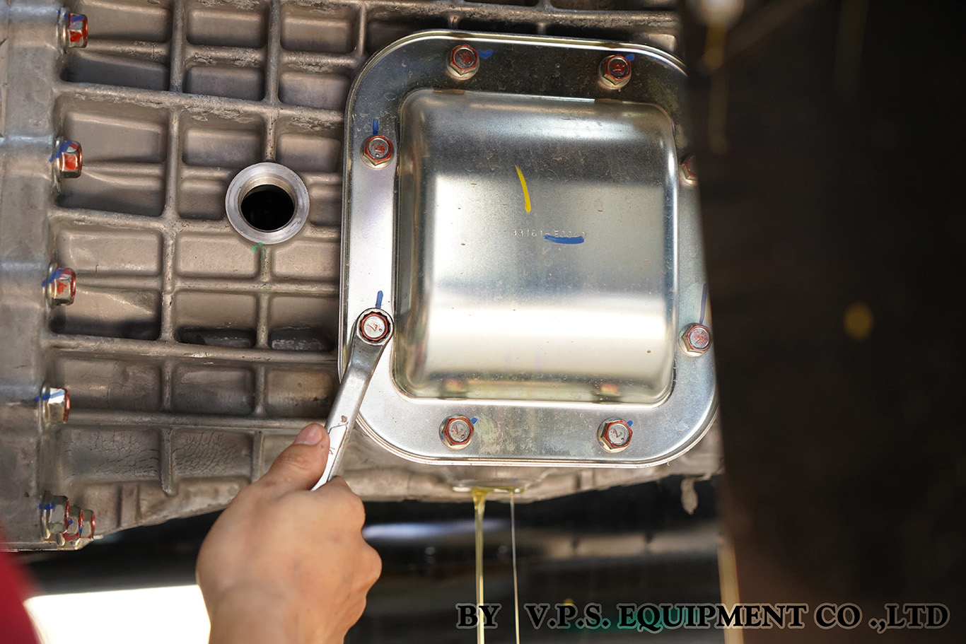 Technician checking gear oil during PTO maintenance service